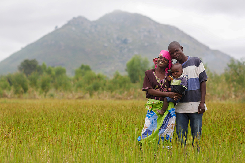 Sarah Gavinala with her husband Witinesi and their son Bashil outside their home in Zomba, Malawi