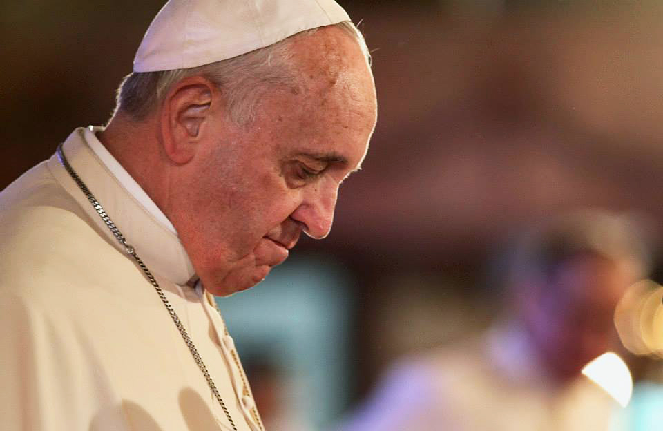 Pope Francis bows his head