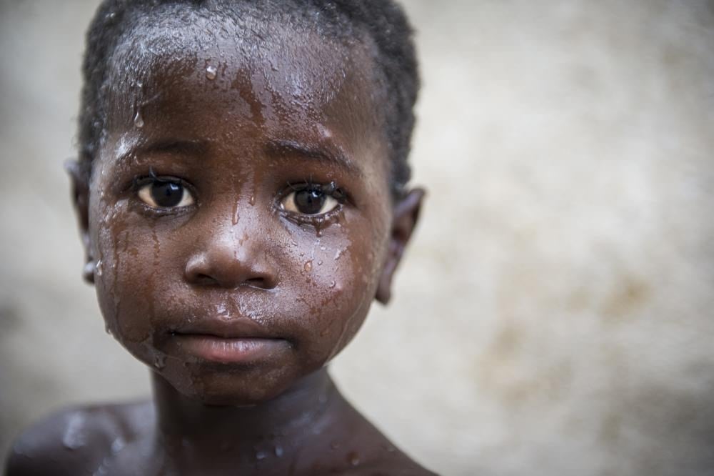 Boy in the rain waiting for help