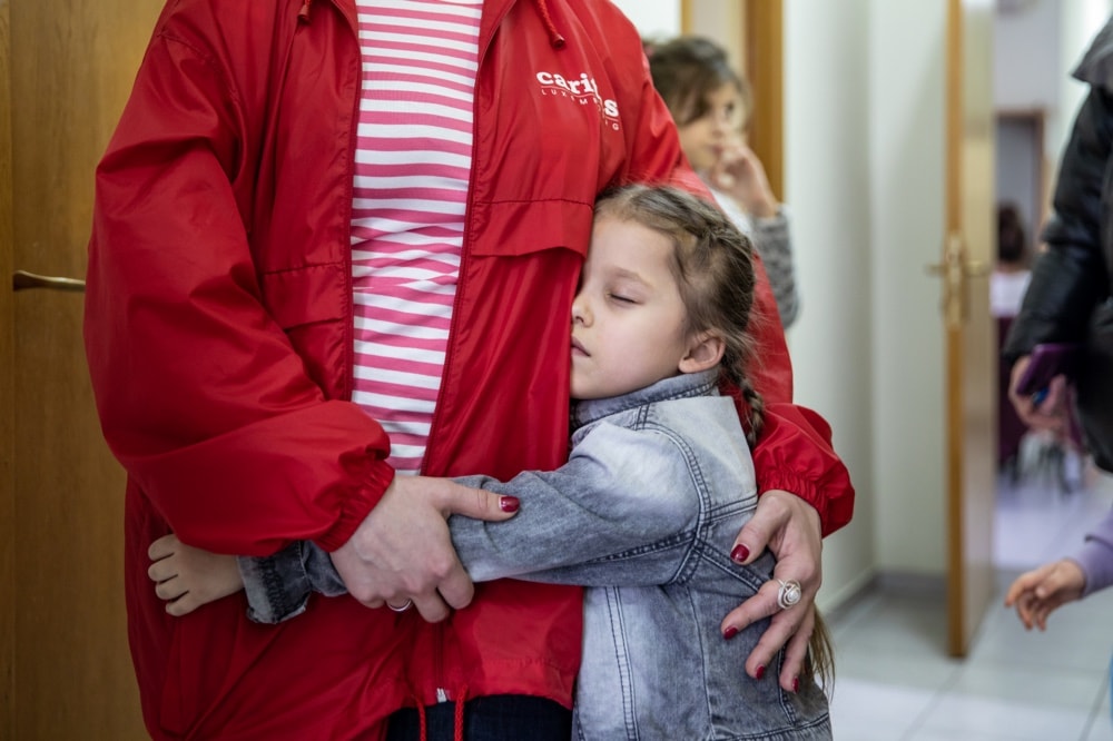 A Ukrainian girl hugging a family member