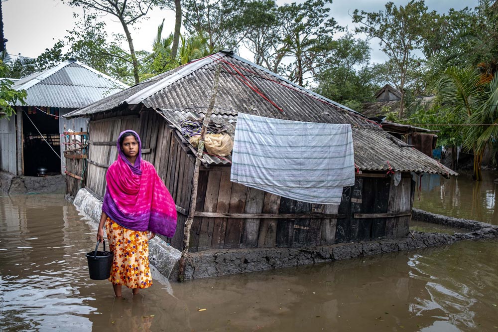 A cyclone flooded the town of Munshigong in Bangladesh. Bangladesh is experiencing more frequent and intense storms due to climate change, harming communities already vulnerable to poverty. Photo by Amit Rudro for CRS