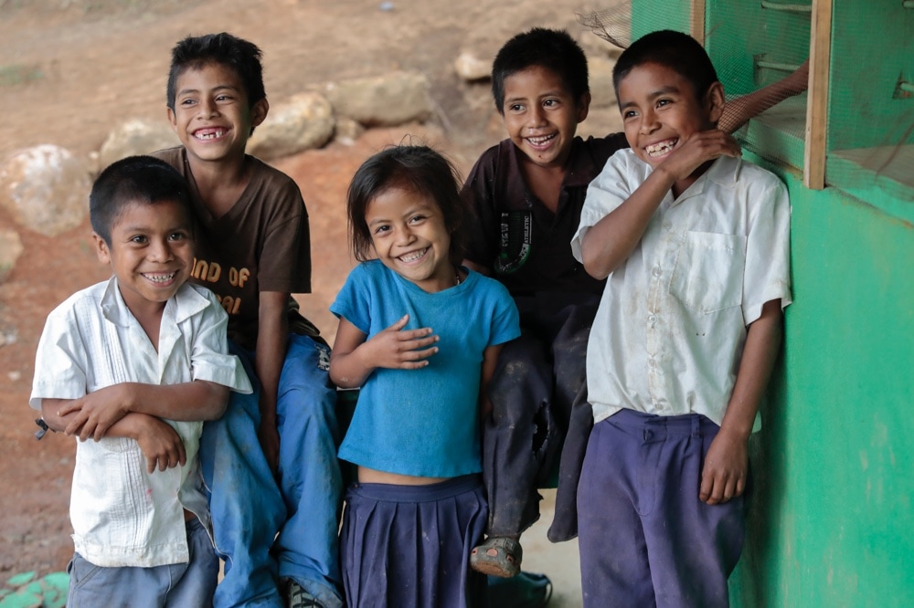 Students from José Suazo Córdova School in San Francisco de Opalaca municipality, Intibucá Honduras smile for the camera after their meal that comes from Catholic Relief Services' Food For Education Program