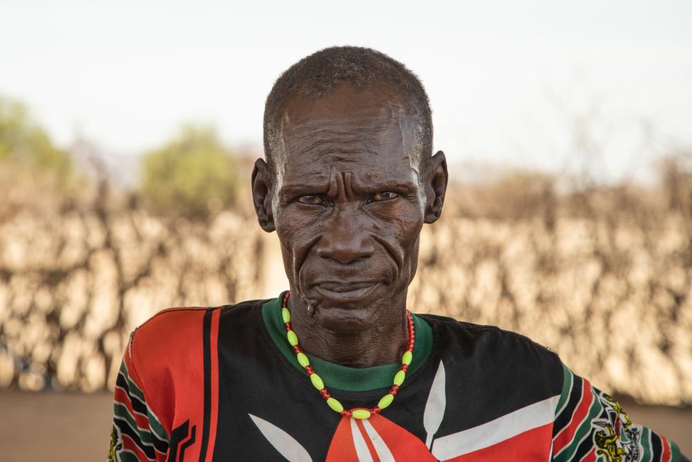 Man standing in front of barren field