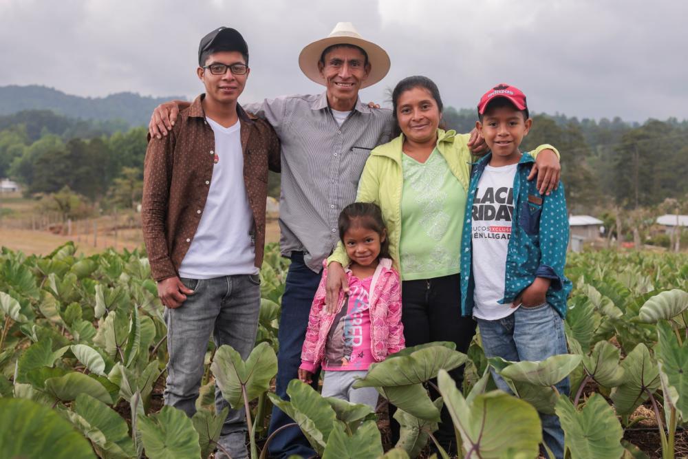 Nery Garcia and his family pose for a photo in his field