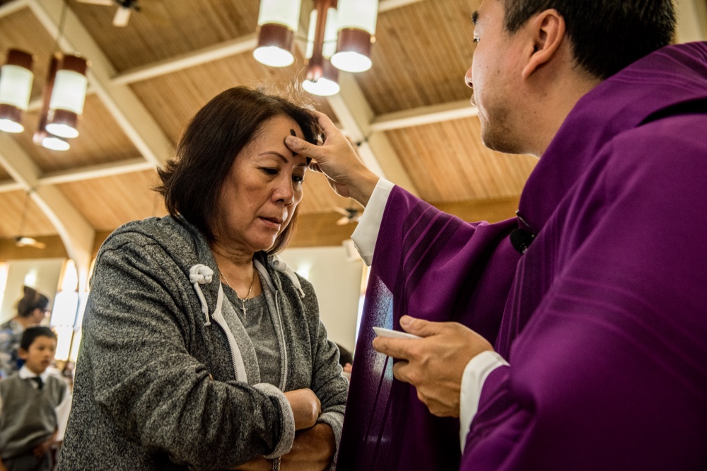 Woman receives cross ashes on Ash Wednesday