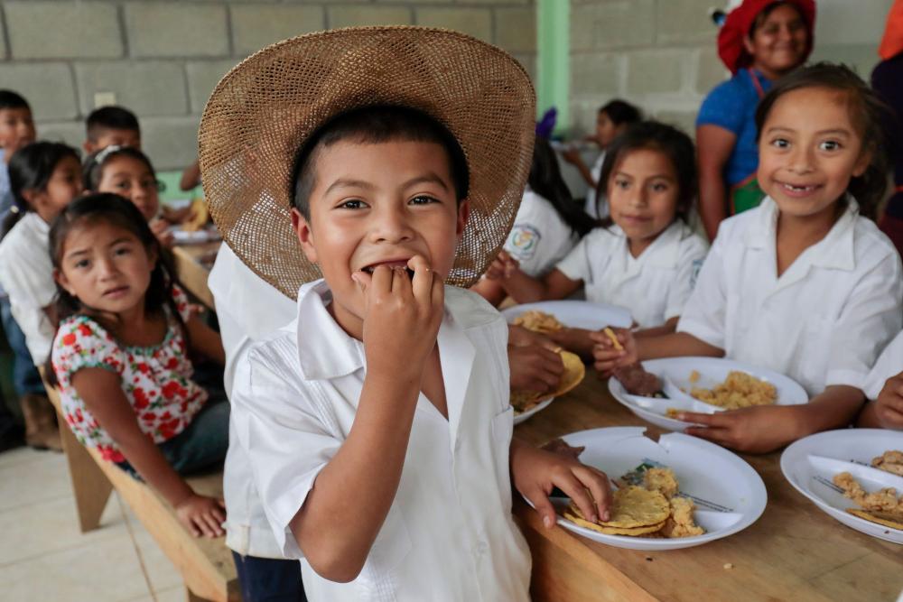 Young students eat school lunch