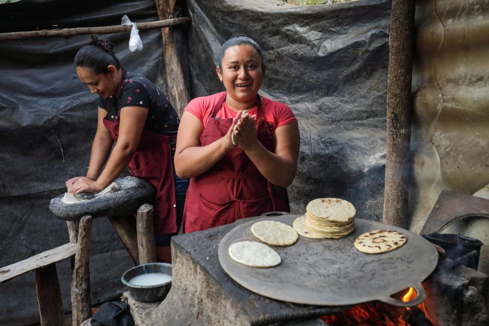 Two women making tortillas in El Salvador