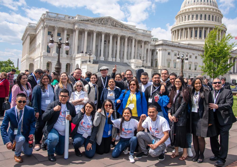 Group of people with the Capitol of the US in the background
