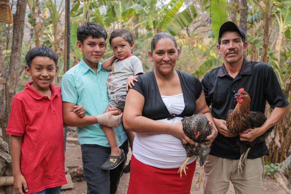 A family holding chickens