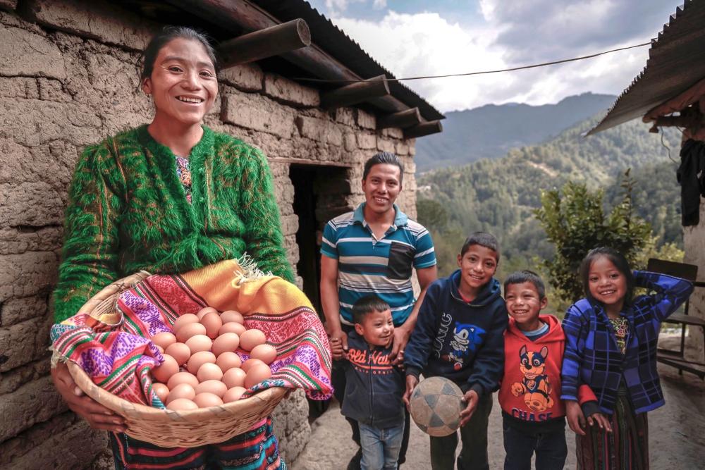 Woman from Guatemala holds a basket full of eggs