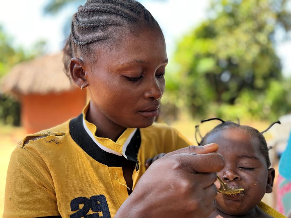 Woman feeds child