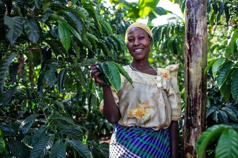 Woman smiling by a tree.